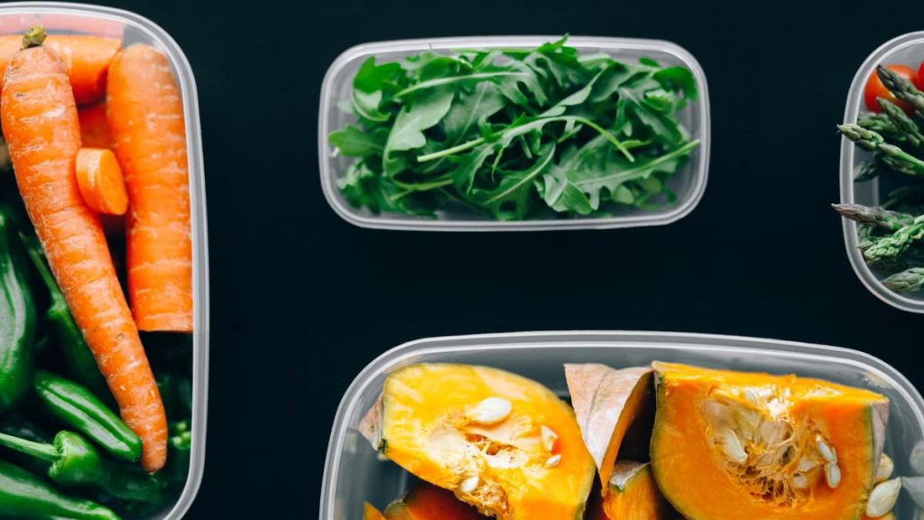 Healthy vegetables stored in plastic containers for fresh and nutritious meals.